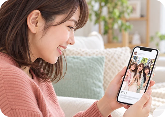 スマホで推しの投稿を見る女性
